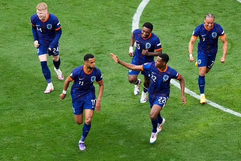 Cody Gakpo celebrates with teammates after scoring the opening goal